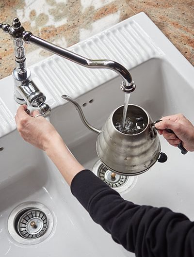 woman-hands-filling-a-kettle-with-tap-water-over-t-2024-05-10-16-07-04-utc